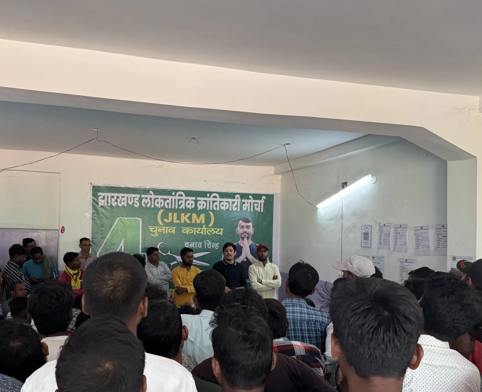 Ayush Jain addressing party workers at an election office